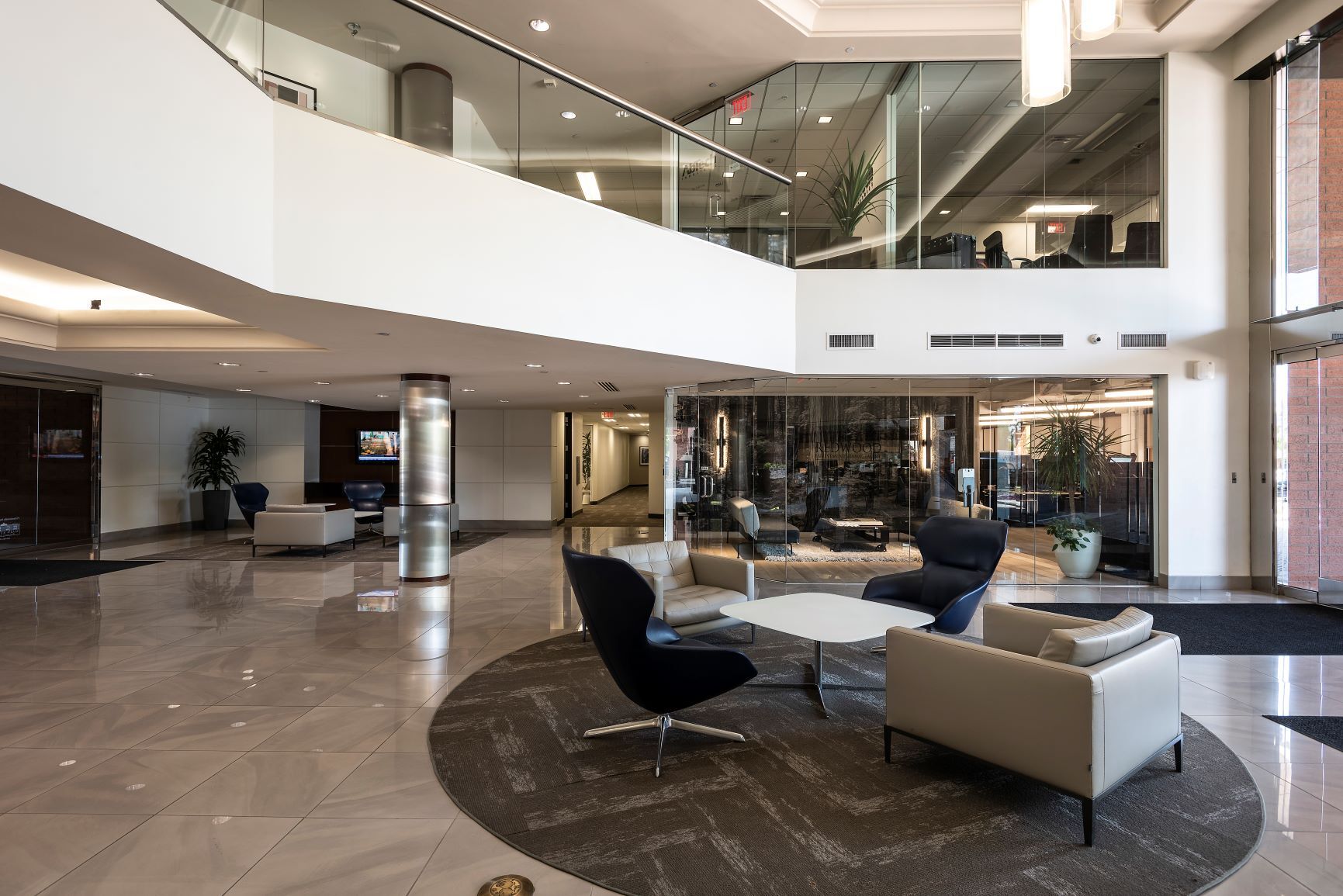 RJP Estate Planning office lobby with modern seating area, two-story atrium, and glass conference rooms